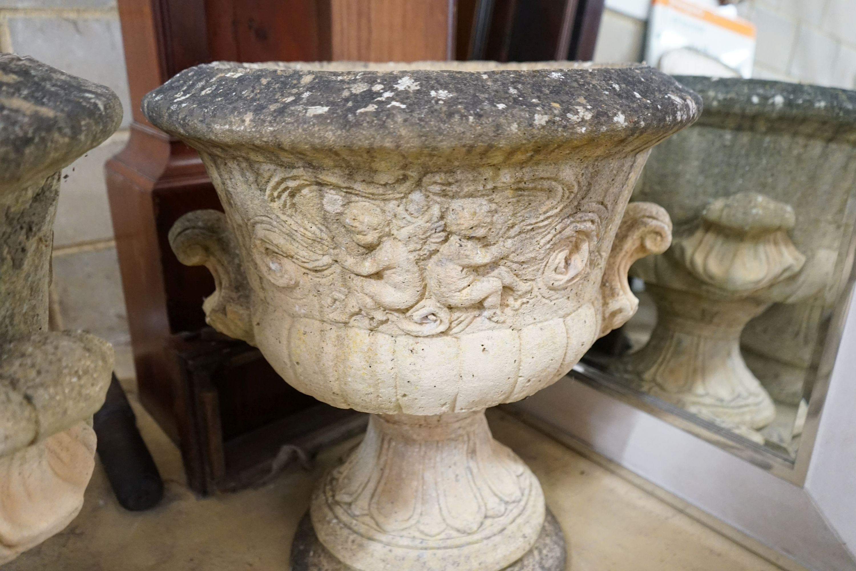 A pair of large circular reconstituted stone garden planters, diameter 56cm, height 63cm